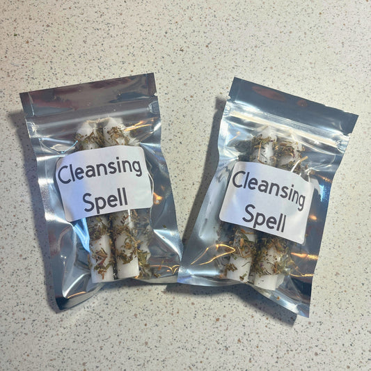 Two packages labeled 'Cleansing Spell' on a speckled countertop.