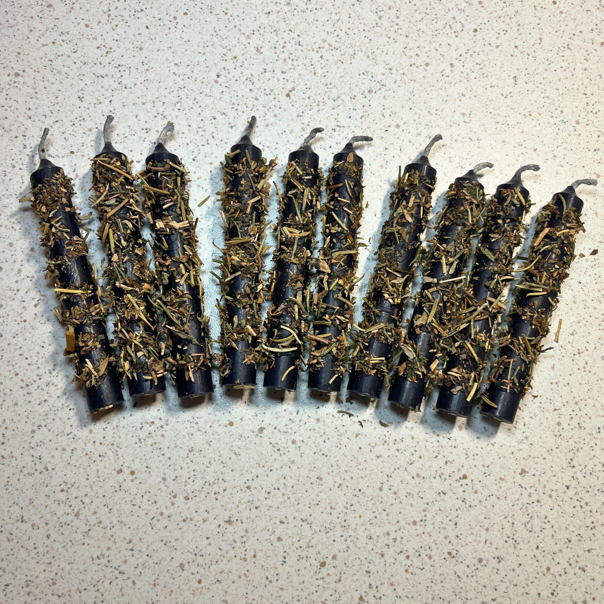 black chime candles dressed with herbs