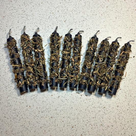 black chime candles dressed with herbs