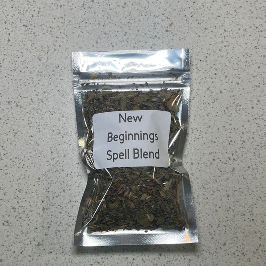 Packaged spell blend labeled 'New Beginnings' on a gray surface