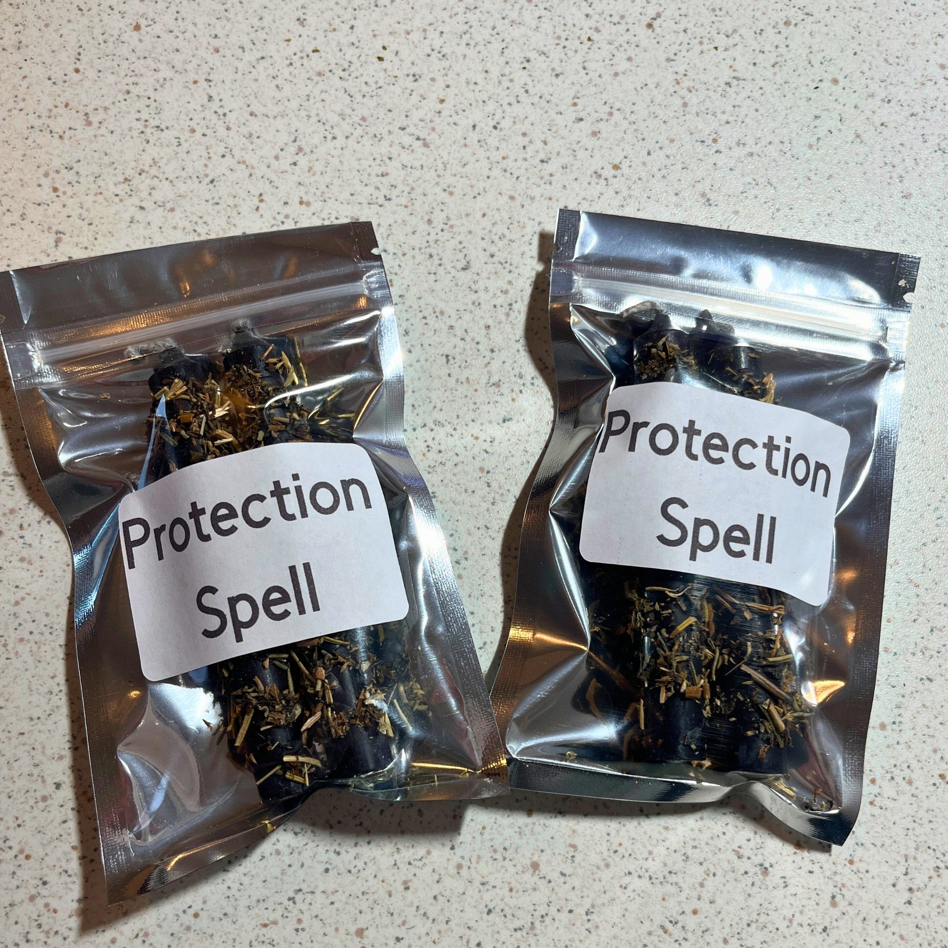 Two packages of herb dressed black chime candles.