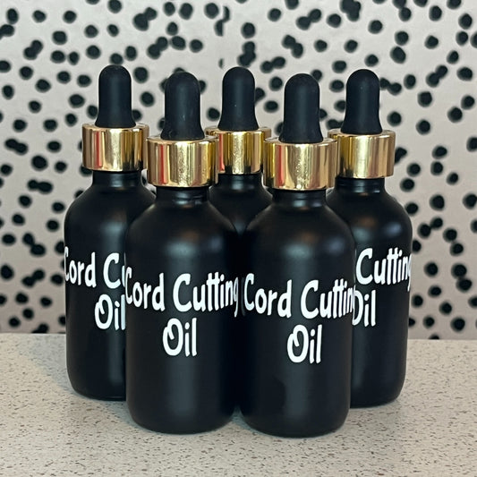 Four black dropper bottles labeled 'Cord Cutting Oil' on a patterned background