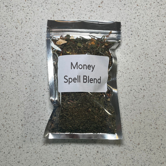 Packaged 'Money Spell Blend' on a speckled gray surface