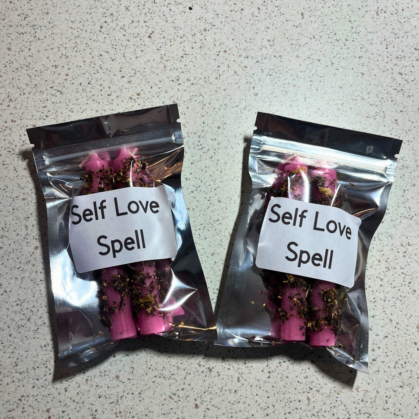 Two packages of dressed self love candles